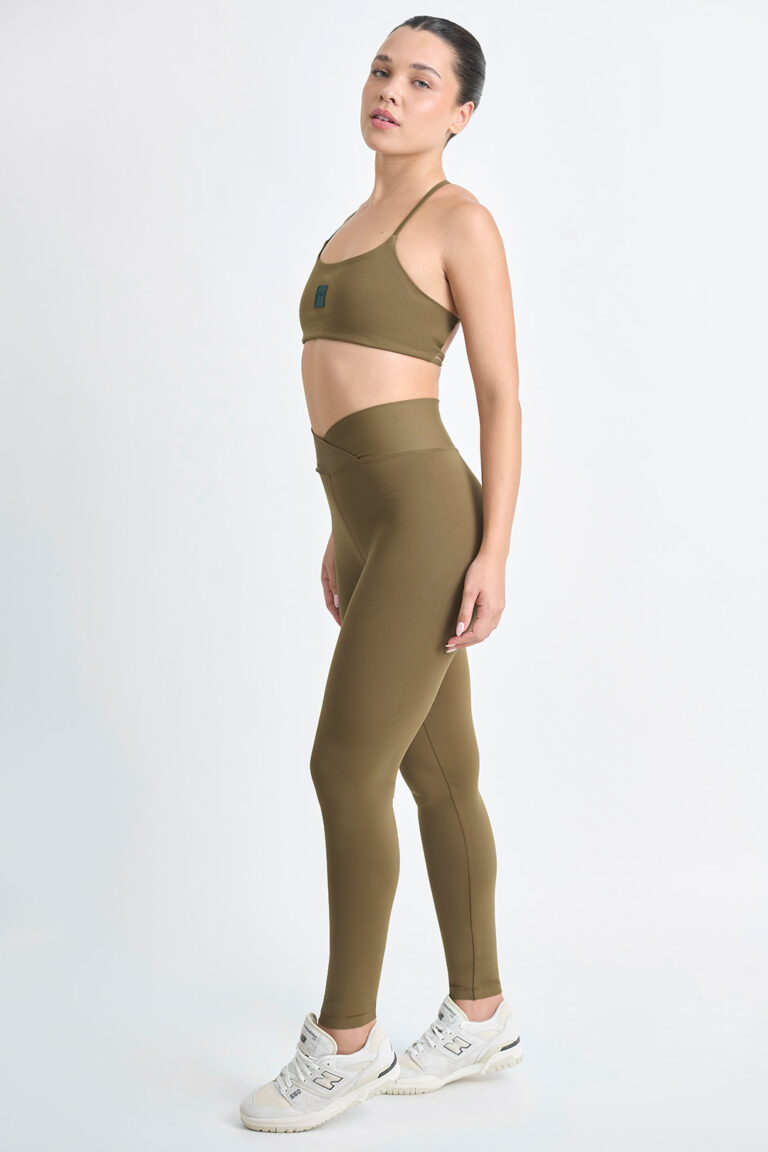 LEGGING KALI SOFT SAVANA: Legging verde oliva com top esportivo e tênis brancos.